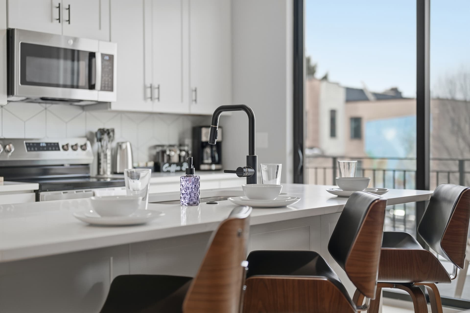 Modern kitchen of short-term rental with city view
